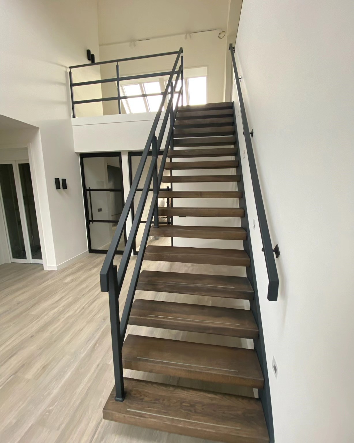 Zwevende trap van staal met houten treden